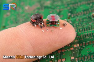 modern electronics surface mount components in comparison to human finger